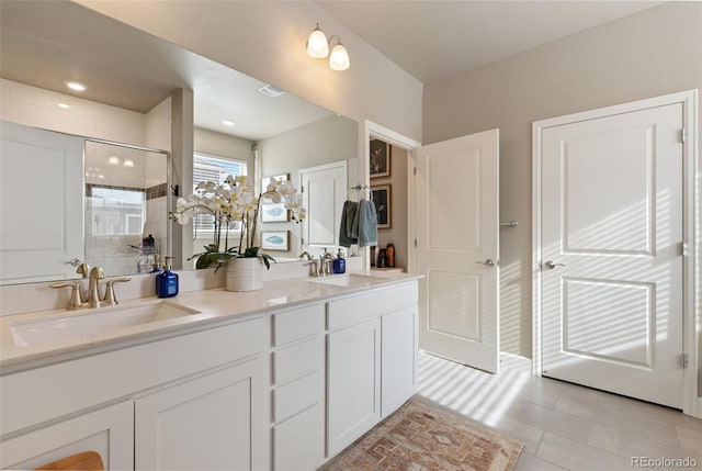 599 Fall River Ct, Brighton, CO 80601 - bathroom featuring double vanity, a shower stall, and tile patterned floors