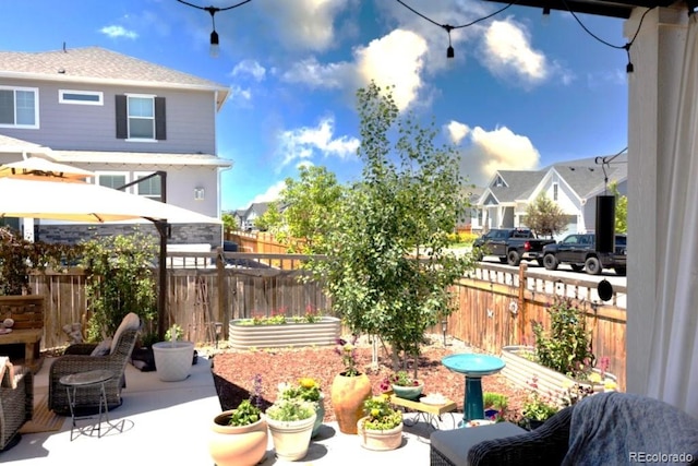 599 Fall River Ct, Brighton, CO 80601 - fenced backyard featuring a residential view and a patio area