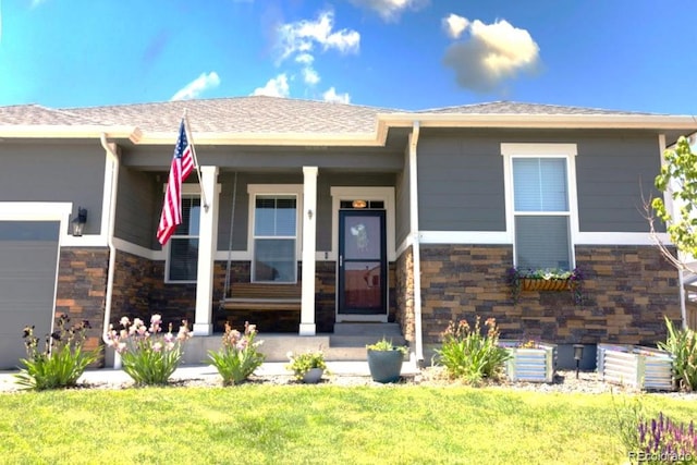 599 Fall River Ct, Brighton, CO 80601 - view of front of property with an attached garage, a front lawn, stone siding, and covered porch