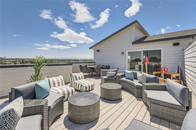 wooden terrace with outdoor dining area and an outdoor living space