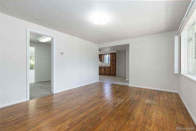 3955 S Hazel Ct, Englewood, CO 80110 - unfurnished room featuring healthy amount of natural light and wood finished floors