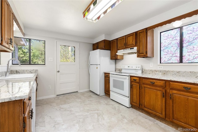 3955 S Hazel Ct, Englewood, CO 80110 - kitchen featuring white appliances, under cabinet range hood, and brown cabinetry