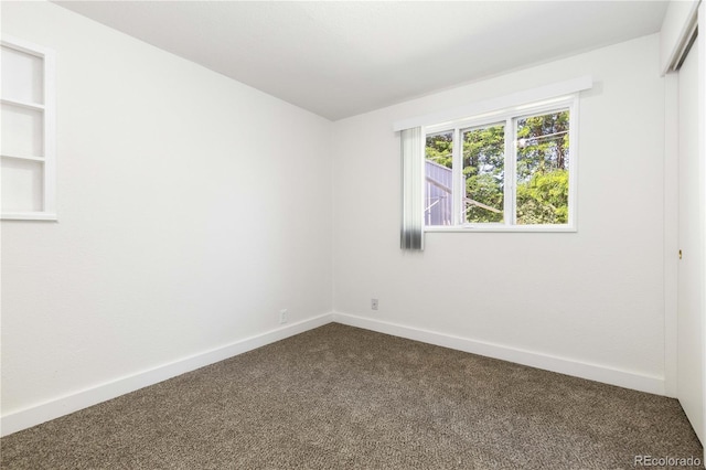 3955 S Hazel Ct, Englewood, CO 80110 - spare room with dark carpet and baseboards