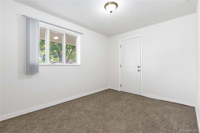 3955 S Hazel Ct, Englewood, CO 80110 - empty room with dark carpet and baseboards