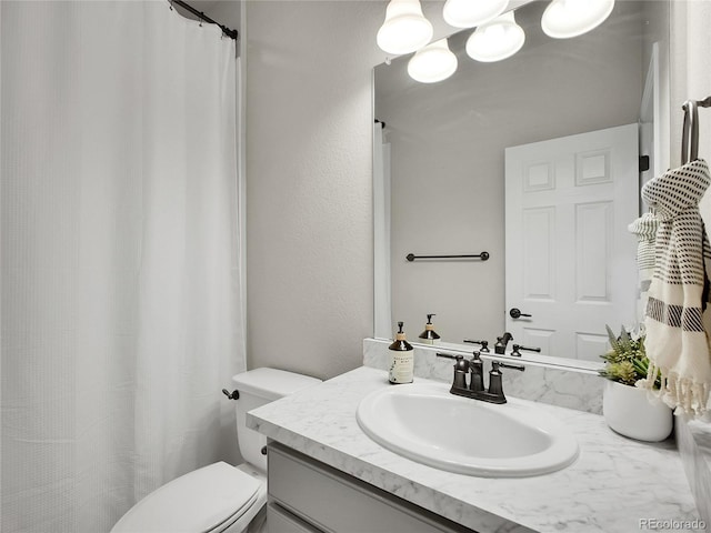 full bathroom featuring toilet and vanity