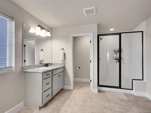 full bathroom featuring a shower stall, vanity, tile patterned flooring, and toilet