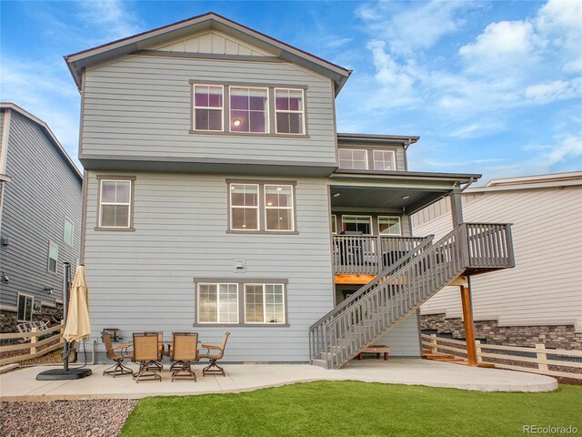back of property with a patio, stairs, a wooden deck, and board and batten siding