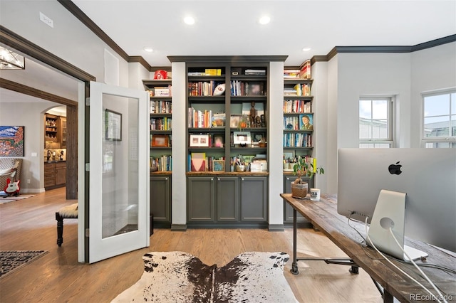 office area featuring ornamental molding and light wood-type flooring