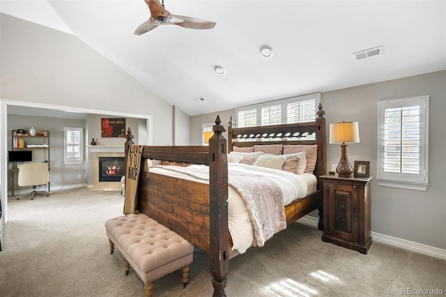 bedroom featuring light carpet, vaulted ceiling, and ceiling fan