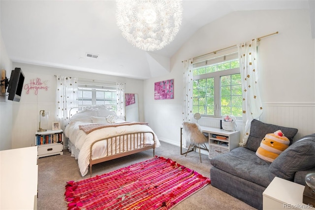 carpeted bedroom with an inviting chandelier and lofted ceiling