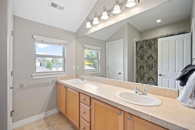 bathroom with a shower with curtain, tile patterned flooring, vanity, and lofted ceiling