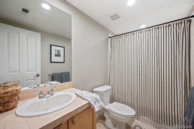 bathroom featuring vanity, curtained shower, and toilet