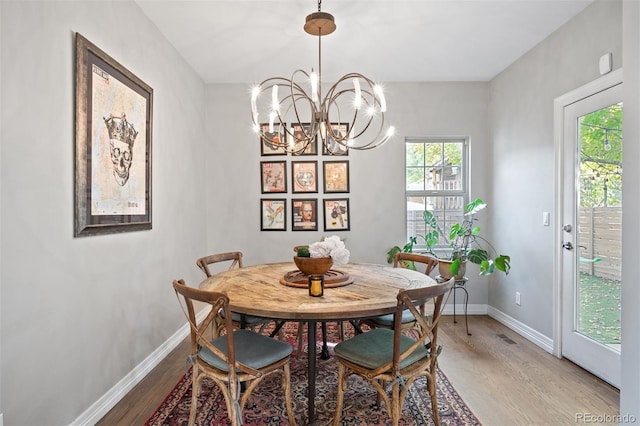 dining room with a chandelier and hardwood / wood-style flooring