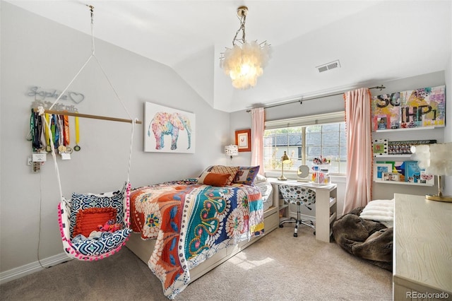 carpeted bedroom featuring a notable chandelier and vaulted ceiling