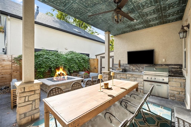 view of patio / terrace featuring ceiling fan, area for grilling, and an outdoor fire pit