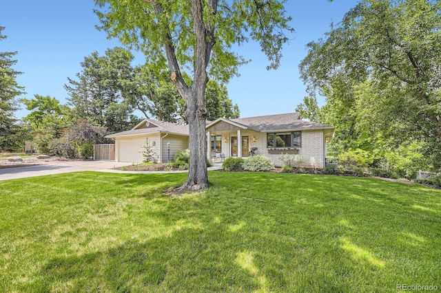 5475 W Ottawa Ave, Littleton, CO 80128 - view of front of property with driveway, a front lawn, brick siding, and an attached garage