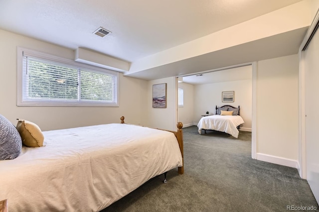 5475 W Ottawa Ave, Littleton, CO 80128 - bedroom featuring dark colored carpet and baseboards