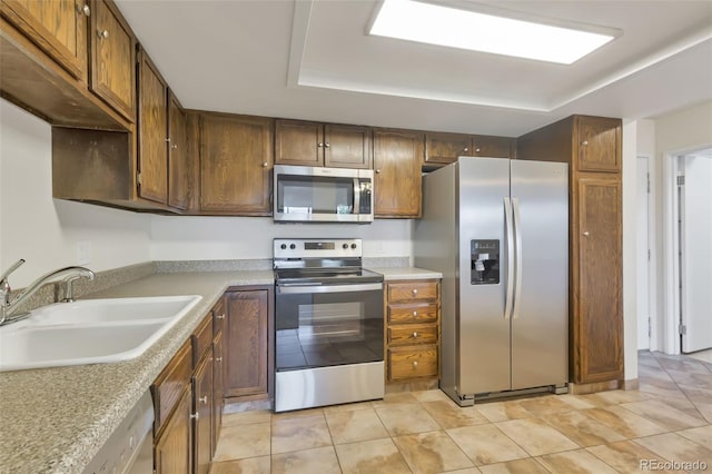 14001 E Marina Dr Unit 606, Aurora, CO 80014 - kitchen featuring stainless steel appliances, a sink, a raised ceiling, and light countertops