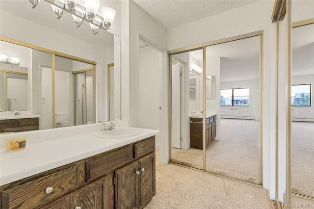 14001 E Marina Dr Unit 606, Aurora, CO 80014 - full bath with vanity, a baseboard heating unit, toilet, and a textured ceiling