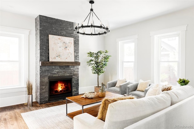 living room featuring a wealth of natural light, a chandelier, and dark hardwood / wood-style floors