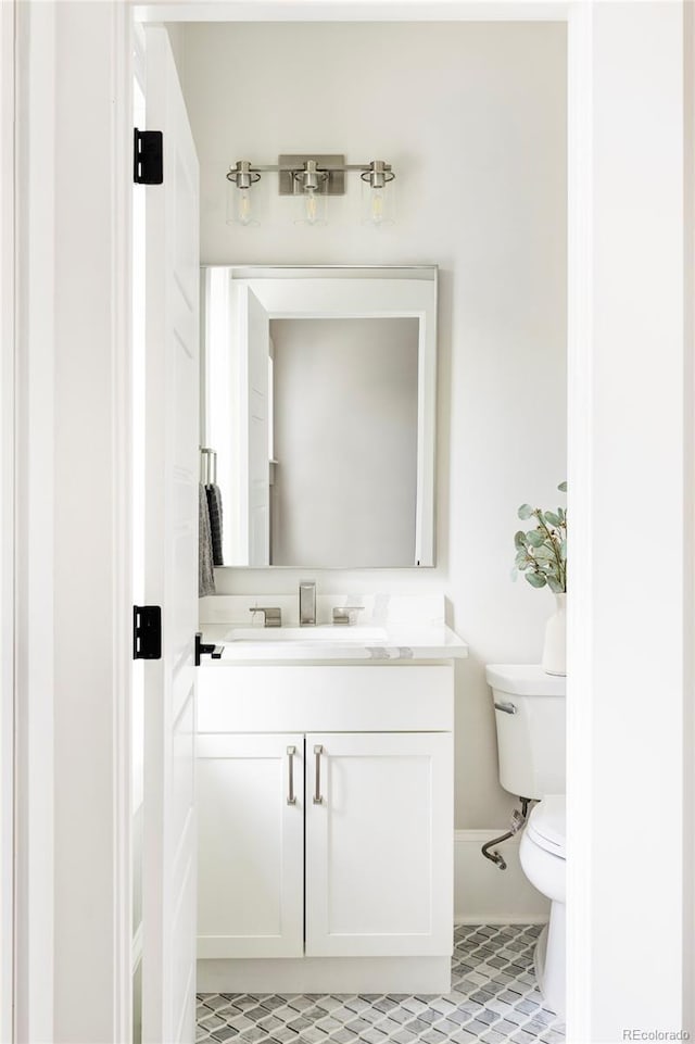 bathroom with tile patterned floors, vanity, and toilet