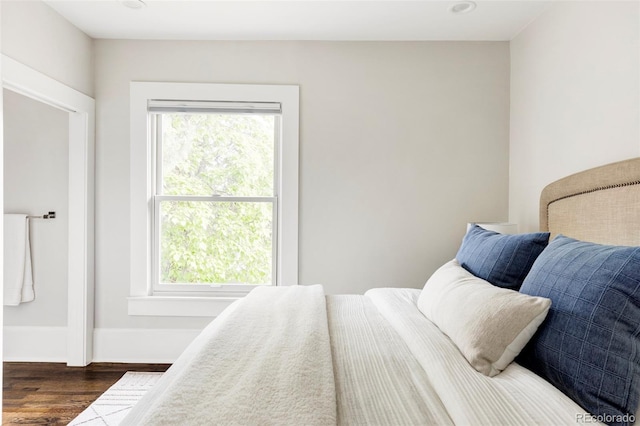 bedroom featuring dark hardwood / wood-style flooring and multiple windows