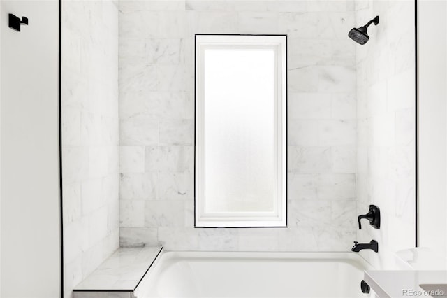 bathroom with vanity and tiled shower / bath combo