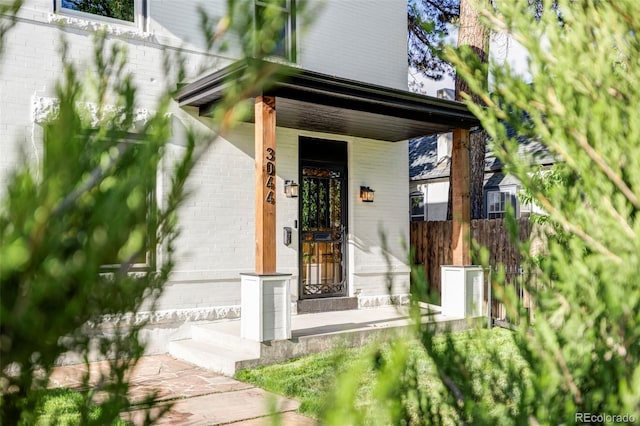 doorway to property featuring covered porch