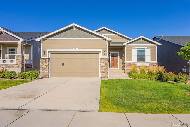 craftsman-style house featuring a garage and a front lawn