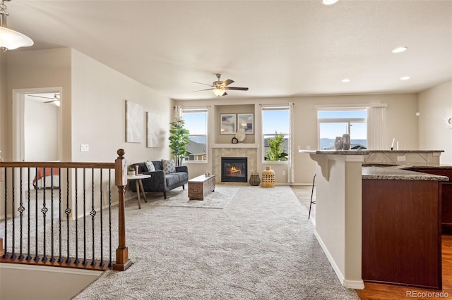 living room featuring light colored carpet and ceiling fan