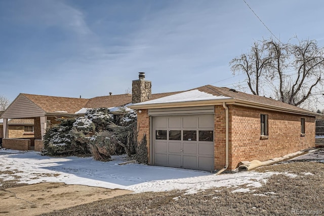 exterior space featuring brick siding and a chimney