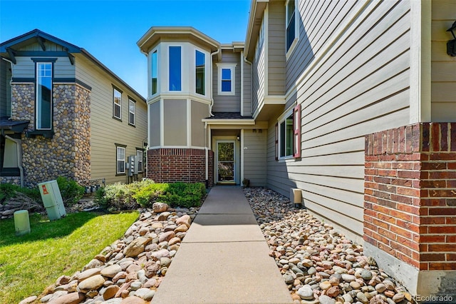 view of exterior entry with brick siding
