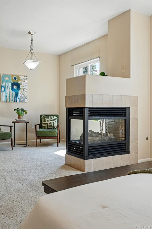 carpeted living room with baseboards and a fireplace
