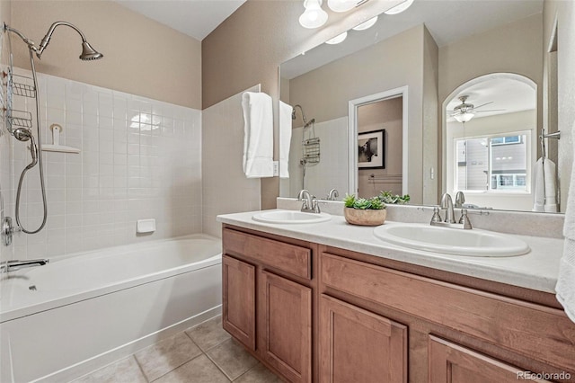 bathroom with a ceiling fan, tile patterned flooring, bathing tub / shower combination, and a sink