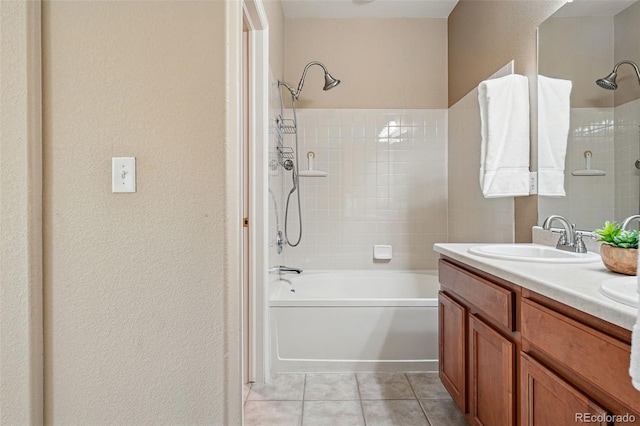 bathroom with a sink, tile patterned floors, double vanity, washtub / shower combination, and a textured wall