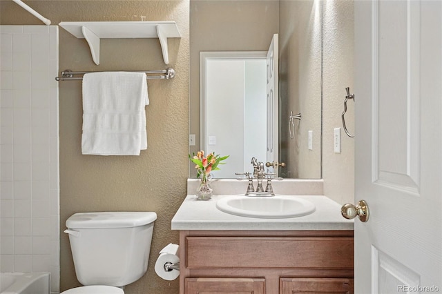 full bathroom featuring vanity, toilet, a textured wall, and  shower combination