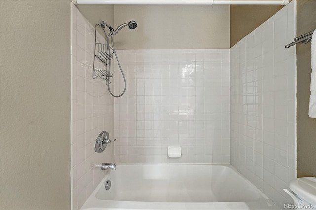 bathroom with toilet and tub / shower combination