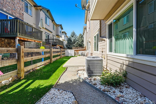 view of yard with cooling unit, a patio area, a residential view, and a fenced backyard