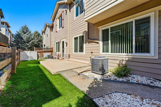 view of yard with central AC, a patio, and fence