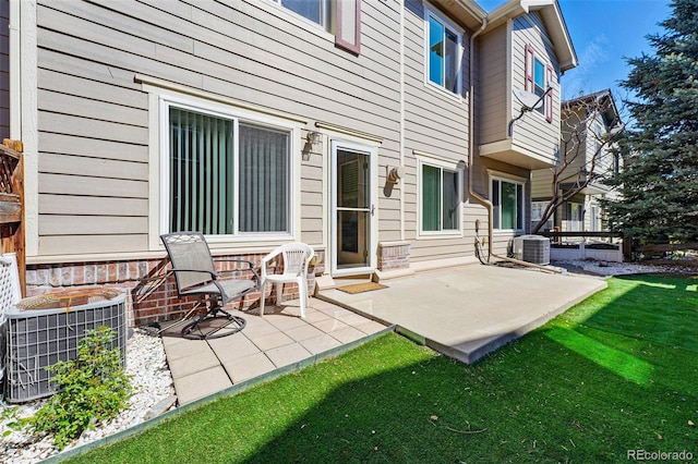 back of property featuring a patio area, cooling unit, and a lawn
