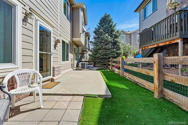 view of yard with central AC unit, a patio, and a fenced backyard
