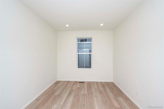 spare room featuring light hardwood / wood-style flooring