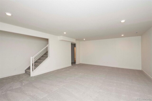 basement featuring light carpet