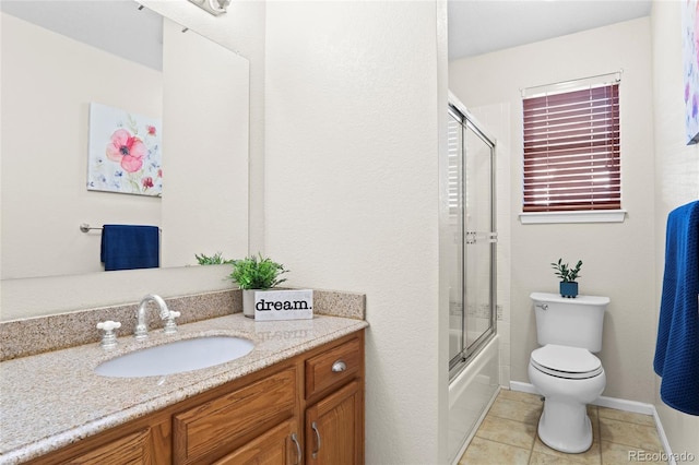 full bathroom with tile patterned flooring, vanity, toilet, and combined bath / shower with glass door