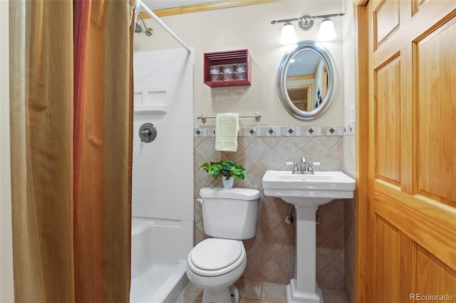 bathroom with tile patterned floors, toilet, tile walls, and walk in shower