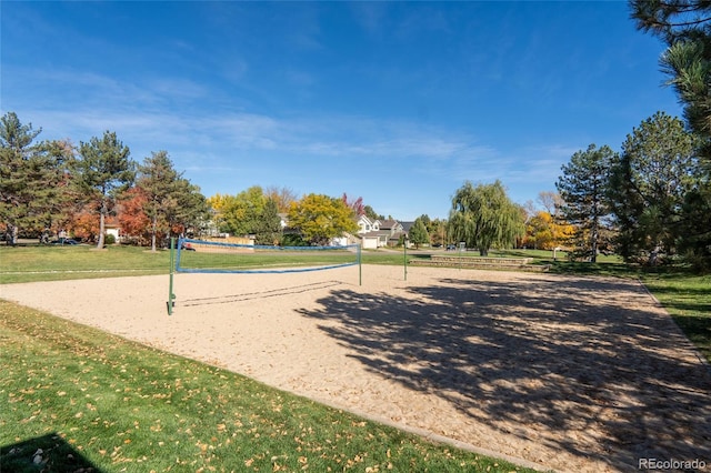 surrounding community with a lawn and volleyball court