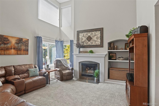 living room with light carpet and a high ceiling