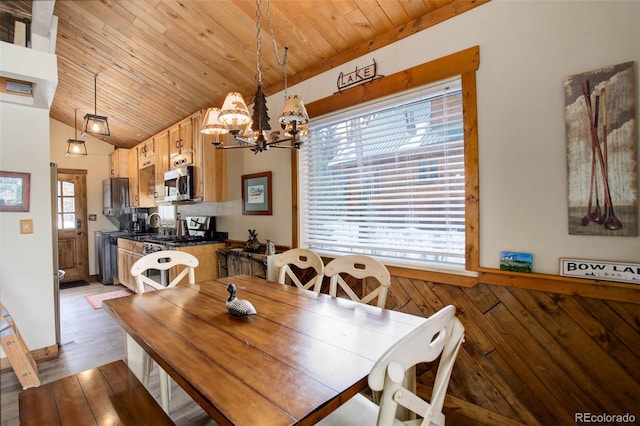 dining space featuring wood ceiling, hardwood / wood-style floors, a healthy amount of sunlight, and vaulted ceiling