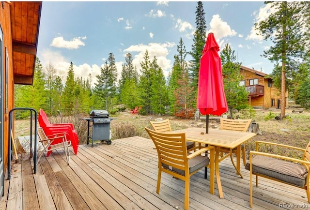 wooden deck featuring a grill