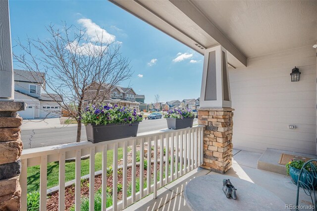 balcony featuring covered porch and a residential view